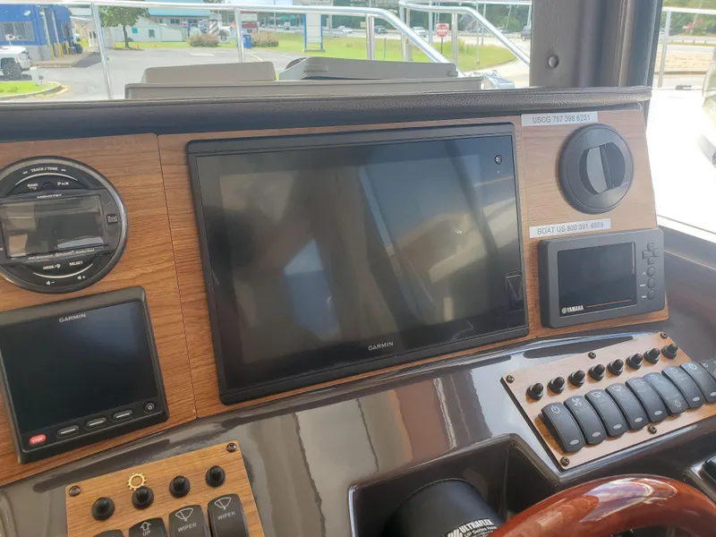 Slide: The Image of Control panel of a 2020 Ranger Tugs 25 boat with navigation screens and controls. - 13