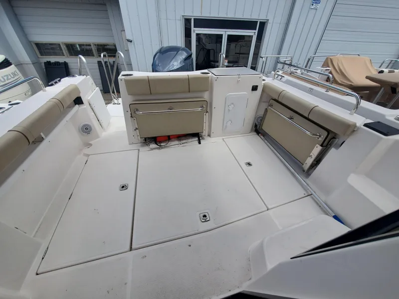 Slide: The Image of 2020 Ranger Tugs 25 boat deck with seating and storage compartments. - 16