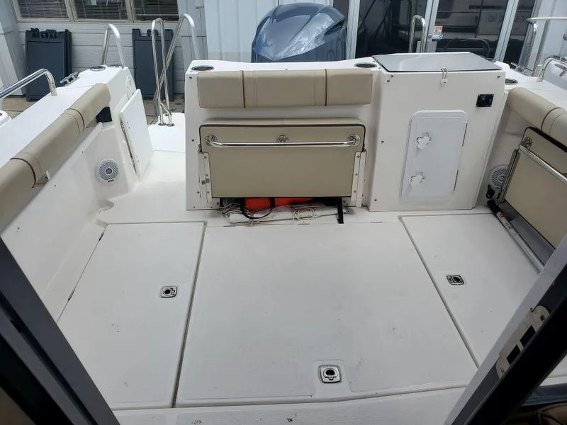 Slide: The Image of 2020 Ranger Tugs 25 boat deck with seating and storage compartments. - 17