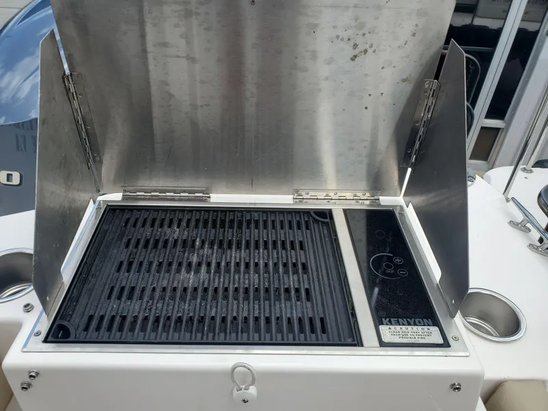 Slide: The Image of Outdoor grill on a 2020 Ranger Tugs 25 boat, featuring a Kenyon cooking surface. - 18