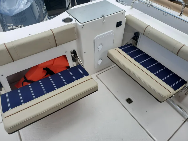 Slide: The Image of 2020 Ranger Tugs 25 boat interior with cushioned seating and storage compartments. - 19