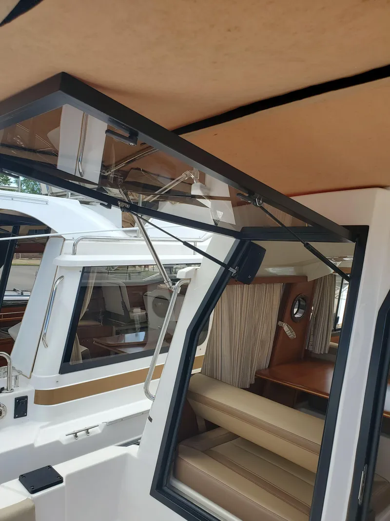 Slide: The Image of 2020 Ranger Tugs 25 interior with seating and window details. - 21