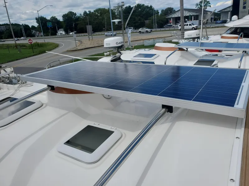 Slide: The Image of Solar panel on 2020 Ranger Tugs 25 boat roof, docked near a road. - 24