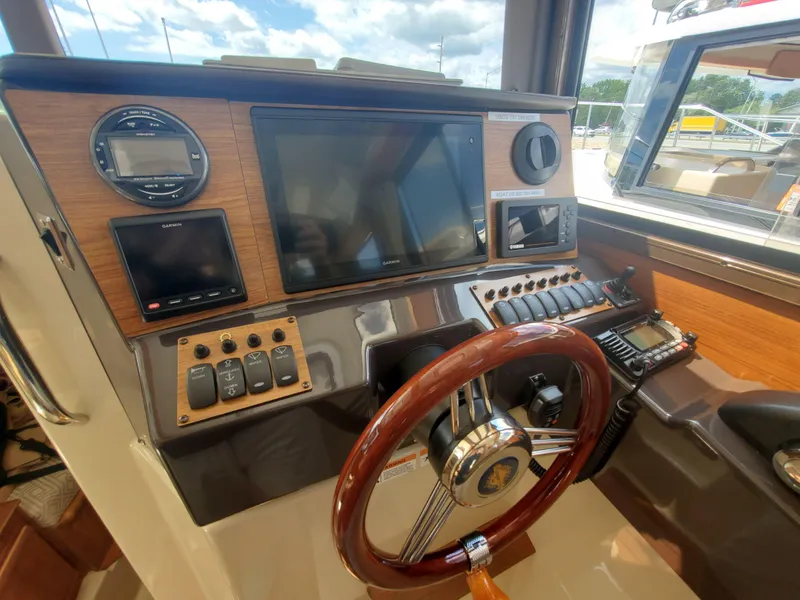 Slide: The Image of 2020 Ranger Tugs 25 helm with modern controls and wooden steering wheel. - 4