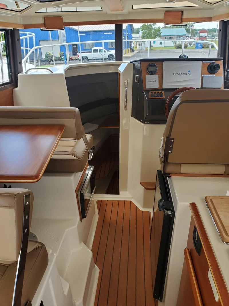 Slide: The Image of 2020 Ranger Tugs 25 interior with wood flooring and modern helm. - 5