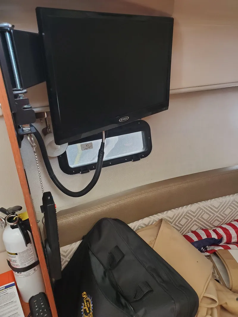 Slide: The Image of Interior of a 2020 Ranger Tugs 25 boat with mounted TV and storage area. - 8