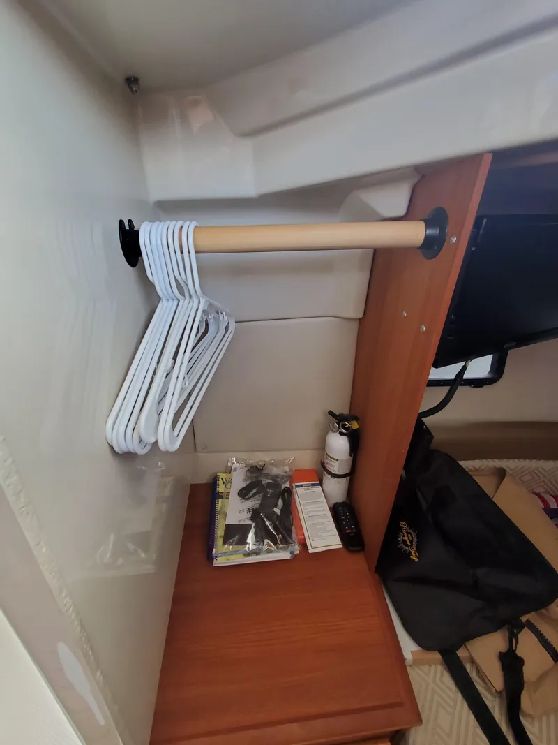 Slide: The Image of Interior of 2020 Ranger Tugs 25 with hangers and storage shelf. - 9