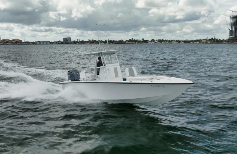 The Image of 2024 Rambo 27 boat cruising on open water under cloudy skies. - 0