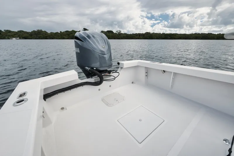 Slide: The Image of 2024 Rambo 27 boat with outboard motor on calm water. - 12