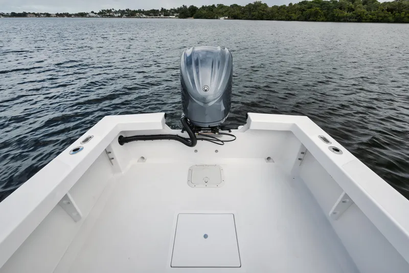 Slide: The Image of 2024 Rambo 27 boat with outboard motor on calm water. - 13