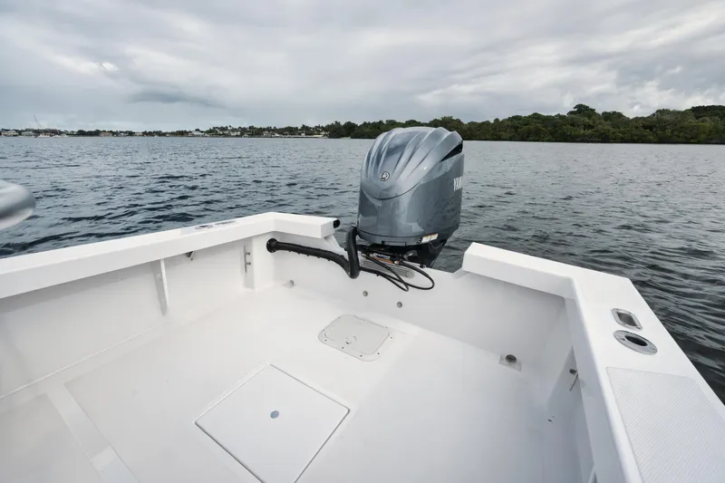 Slide: The Image of 2024 Rambo 27 boat with outboard motor on calm water. - 14