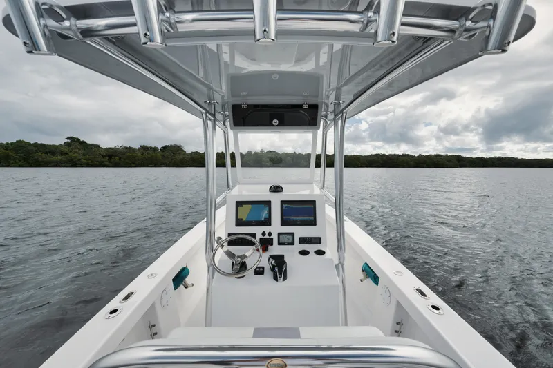 Slide: The Image of 2024 Rambo 27 boat interior with modern navigation system on a calm lake. - 15