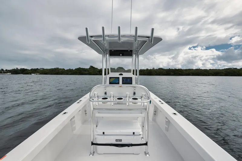 Slide: The Image of 2024 Rambo 27 boat on calm water under cloudy sky. - 16