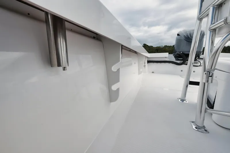 Slide: The Image of 2024 Rambo 27 boat interior with sleek white finish and metal fixtures. - 18