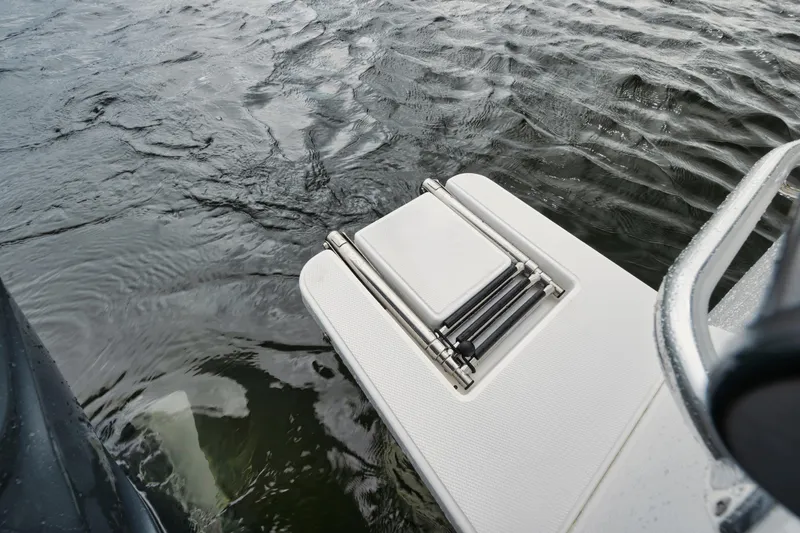 Slide: The Image of Rambo 27 boat swim platform with ladder, 2024 model, on water. - 19