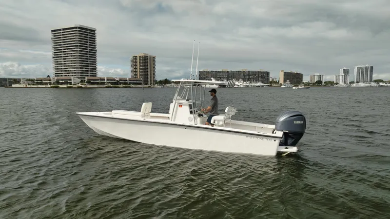 Slide: The Image of 2024 Rambo 27 boat on water with city skyline in background. - 20