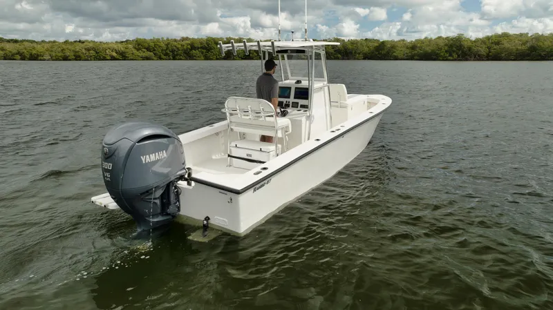 Slide: The Image of 2024 Rambo 27 boat with Yamaha engine on calm water. - 28