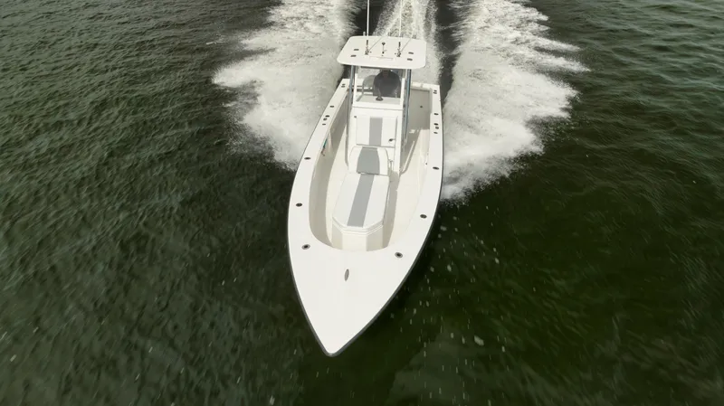 Slide: The Image of 2024 Rambo 27 boat cruising on open water, aerial view. - 29