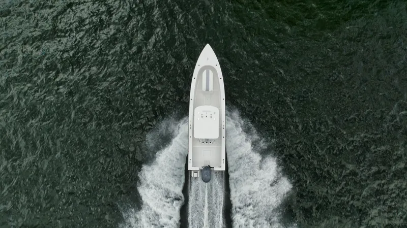 Slide: The Image of Aerial view of 2024 Rambo 27 boat cruising through water. - 33