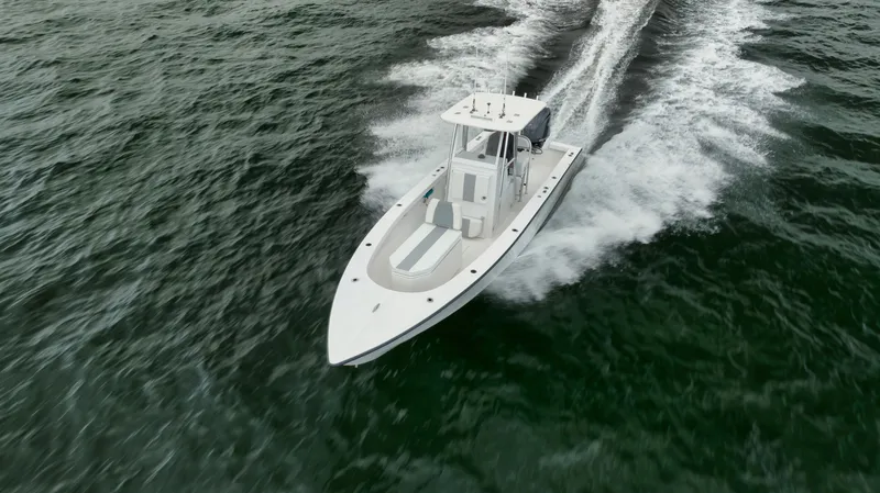 Slide: The Image of 2024 Rambo 27 boat cruising on open water, aerial view. - 34