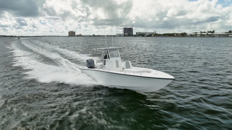 Slide: The Image of 2024 Rambo 27 boat cruising on open water under cloudy skies. - 36
