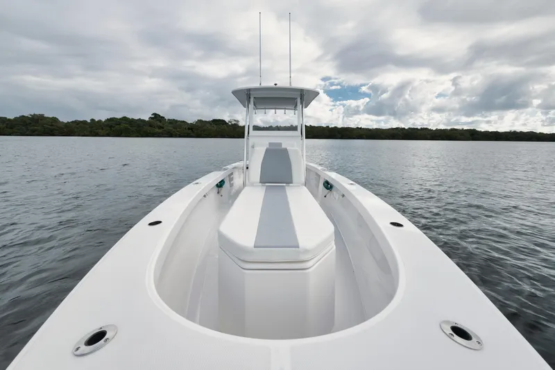 Slide: The Image of 2024 Rambo 27 boat on calm water under cloudy sky. - 6