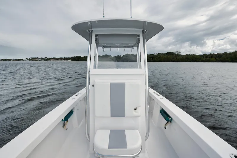 Slide: The Image of 2024 Rambo 27 boat on calm water under cloudy sky. - 7