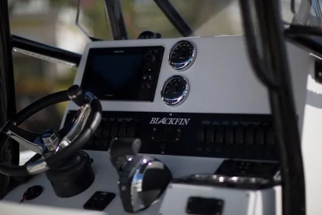 Slide: The Image of 2024 Blackfin 222CC boat dashboard with steering wheel and control panel. - 7