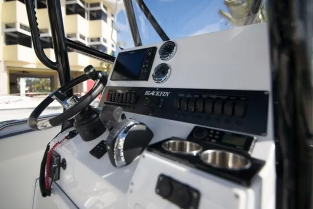 Slide: The Image of 2024 Blackfin 222CC boat dashboard with steering wheel and controls. - 8