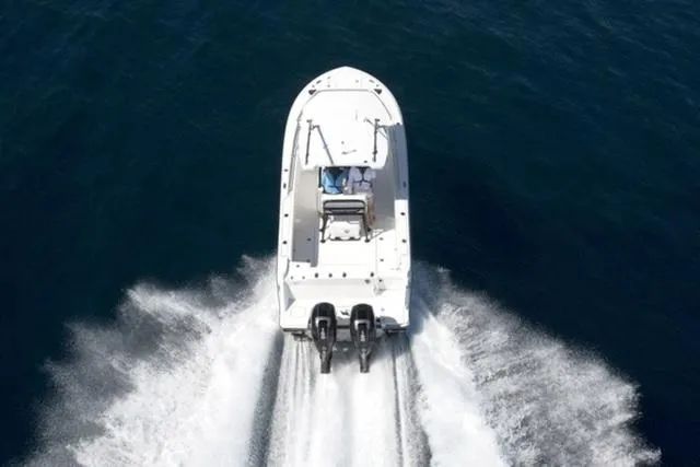 Slide: The Image of 2024 Blackfin 252CC boat cruising on open water, rear view. - 4
