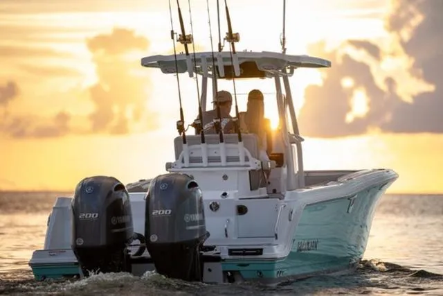 Slide: The Image of 2024 Blackfin 252CC boat with dual Yamaha engines at sunset on the water. - 5
