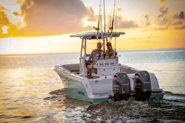Slide: The Image of 2024 Blackfin 252CC boat cruising at sunset with fishing rods. - 6