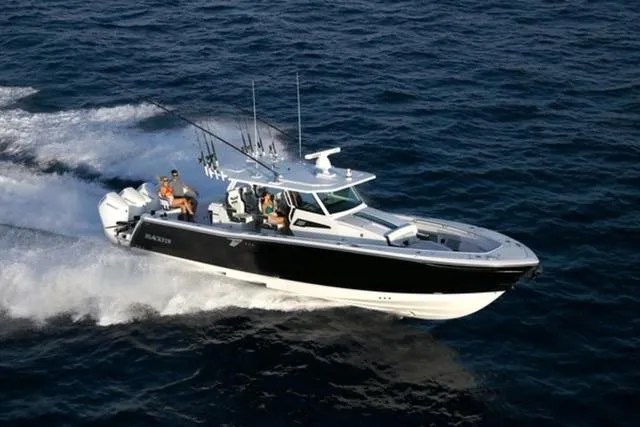 Slide: The Image of 2024 Blackfin 400CC boat cruising on open water with passengers. - 1