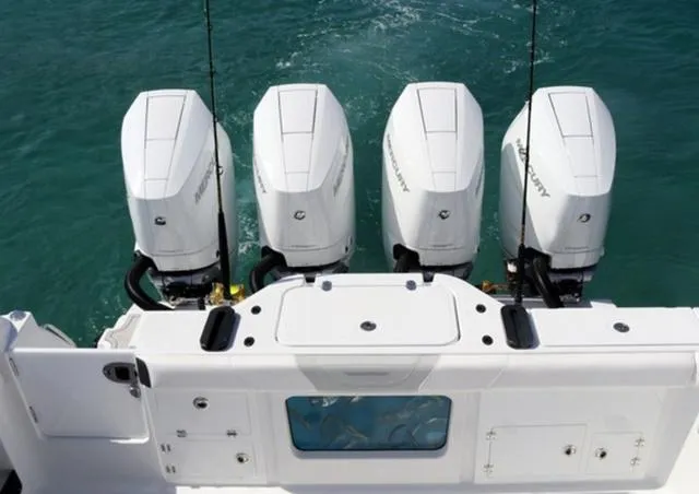 Slide: The Image of 2024 Blackfin 400CC boat with four powerful Mercury outboard engines on turquoise water. - 10