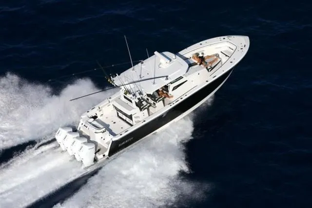 Slide: The Image of 2024 Blackfin 400CC boat cruising on open water, aerial view. - 2