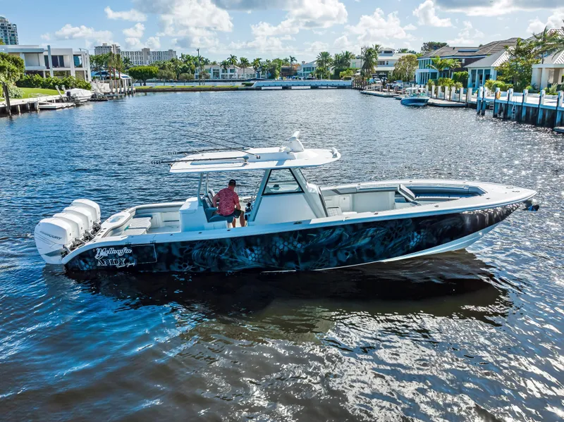 Slide: The Image of 2021 Yellowfin 39 boat cruising on a sunny waterfront. - 17