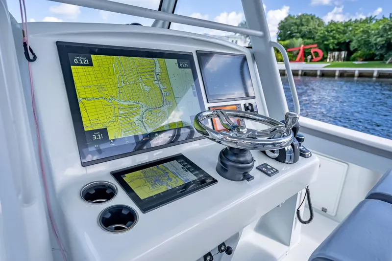 Slide: The Image of 2021 Yellowfin 39 boat dashboard with navigation screens and steering wheel. - 21