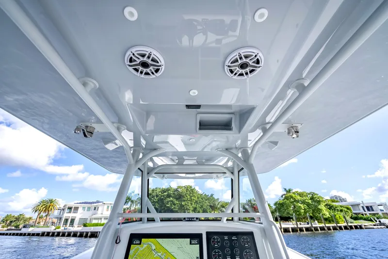 Slide: The Image of 2021 Yellowfin 39 boat console with speakers and navigation system, cruising on a sunny day. - 25