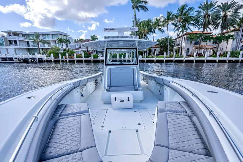 Slide: The Image of 2021 Yellowfin 39 boat with luxurious seating, docked by waterfront homes. - 37