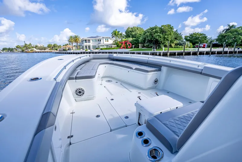 Slide: The Image of 2021 Yellowfin 39 boat interior with waterfront view, clear skies, and luxurious seating. - 38