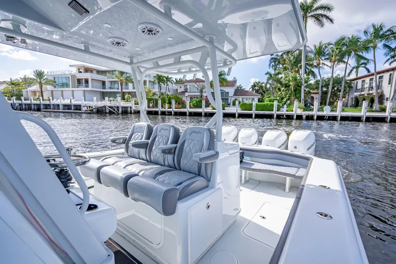 Slide: The Image of 2021 Yellowfin 39 boat with luxurious seating, docked near waterfront homes. - 40