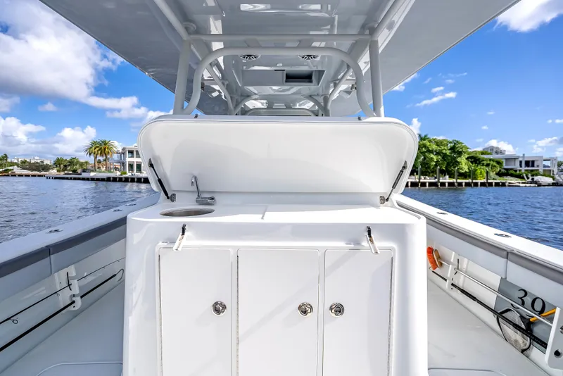 Slide: The Image of 2021 Yellowfin 39 boat interior with storage compartments, docked by a scenic waterfront. - 41