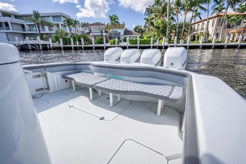 Slide: The Image of 2021 Yellowfin 39 boat with spacious seating, docked near luxury waterfront homes. - 43