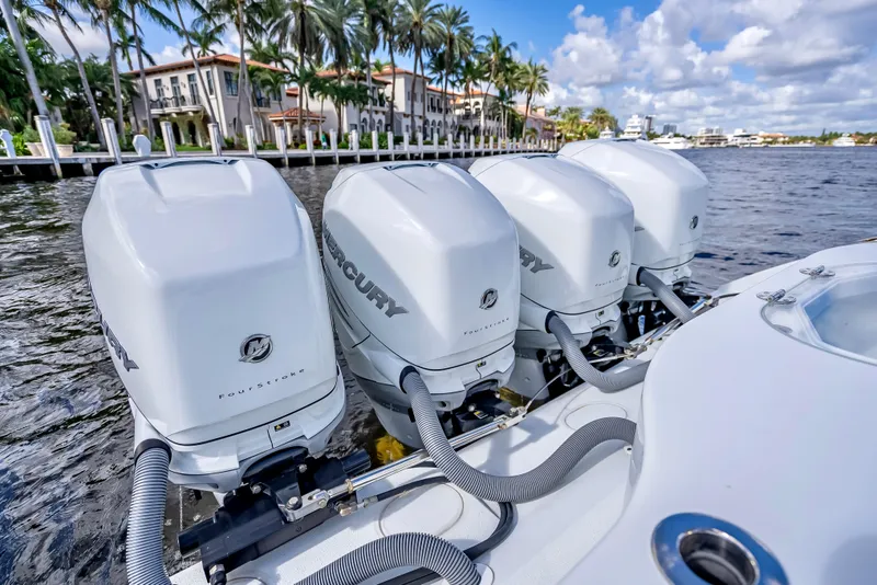 Slide: The Image of 2021 Yellowfin 39 boat with four Mercury outboard engines on a scenic waterfront. - 47
