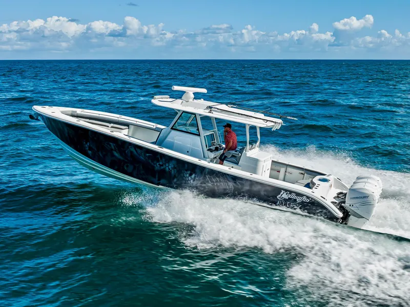 Slide: The Image of 2021 Yellowfin 39 boat cruising on open ocean under clear skies. - 6