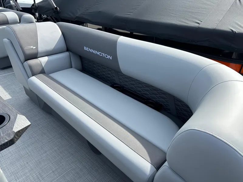 Slide: The Image of 2024 Bennington 20 SSR Quad Bench interior with grey upholstery. - 17