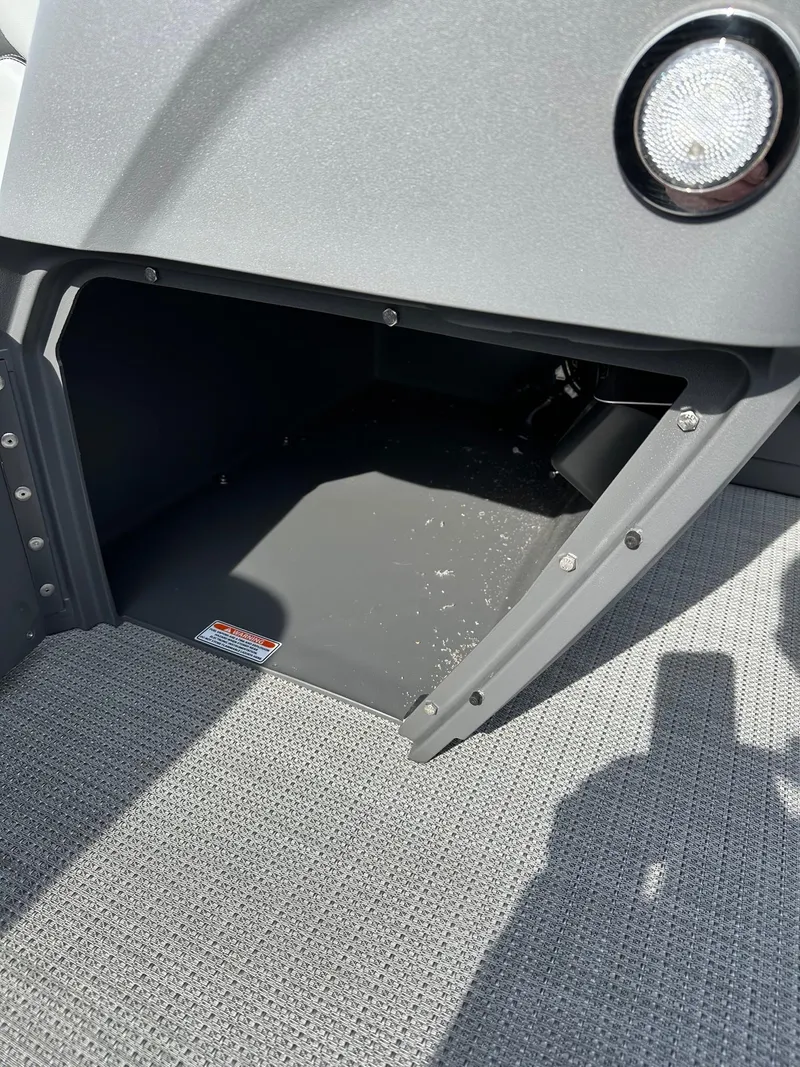 Slide: The Image of Storage compartment of 2024 Bennington 20 SSR Quad Bench pontoon boat. - 19
