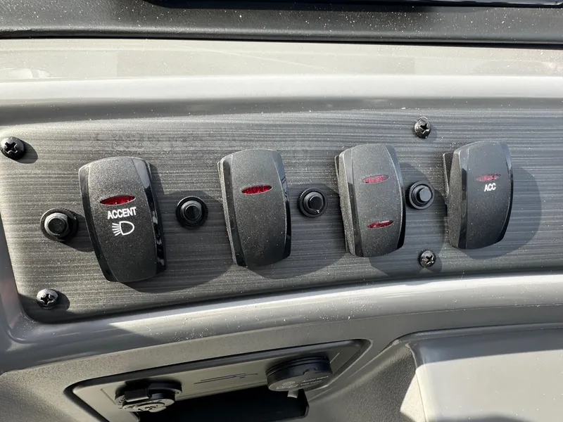 Slide: The Image of Control panel switches on a 2024 Bennington 20 SSR Quad Bench boat. - 22