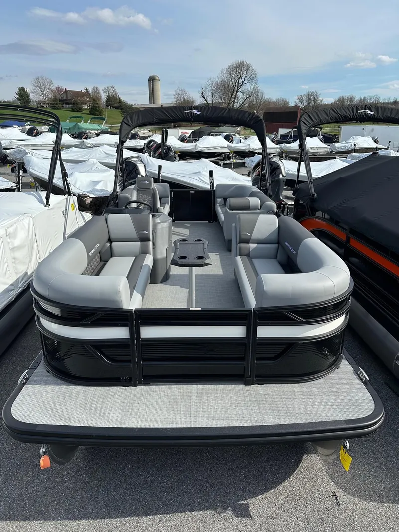 Slide: The Image of 2024 Bennington 20 SSR Quad Bench pontoon boat in stock, displayed outdoors. - 4