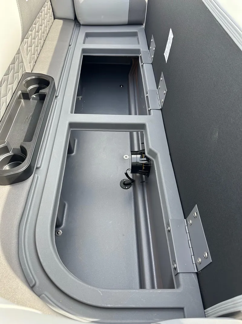 Slide: The Image of 2024 Bennington 20 SSR Quad Bench storage compartment with cup holders. - 5